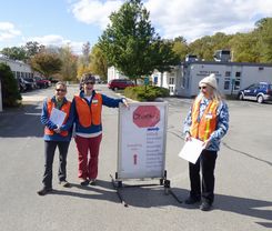 Group of Women Standing Next to DropOff Sign